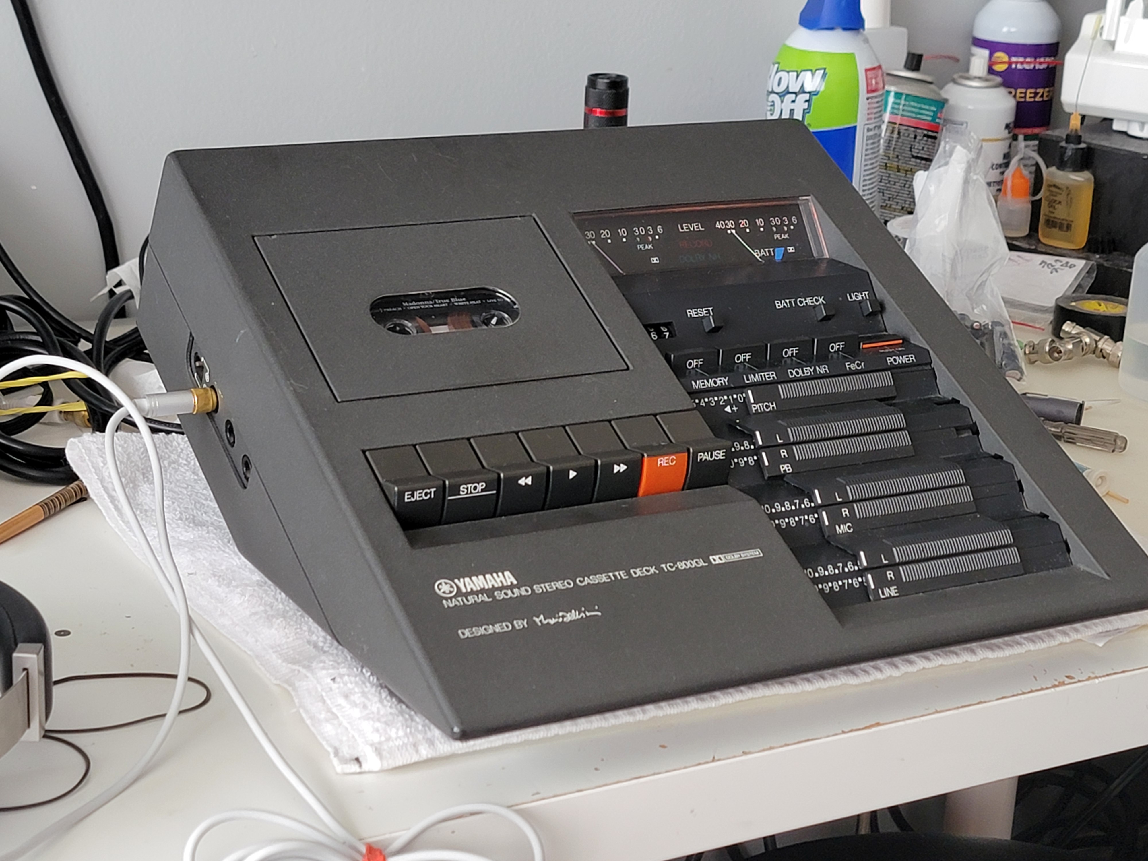A Yamaha TC-800GL cassette deck on the workbench with an oscilloscope and tools